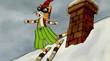 Findus steht auf Skiern. Er fährt ein schneebedecktes Dach runter.