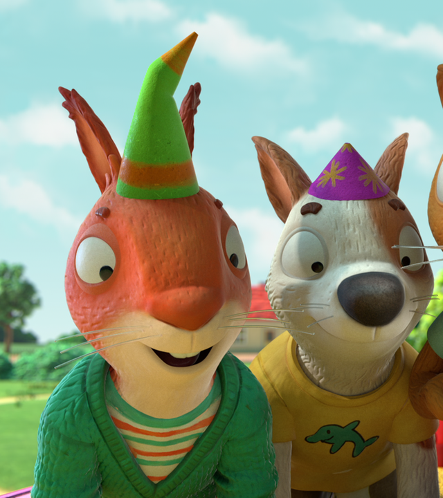 Pip und Posy und ihre Freunde tragen Partyhüte und blicken erfreut und mit großen Augen auf etwas hinunter.