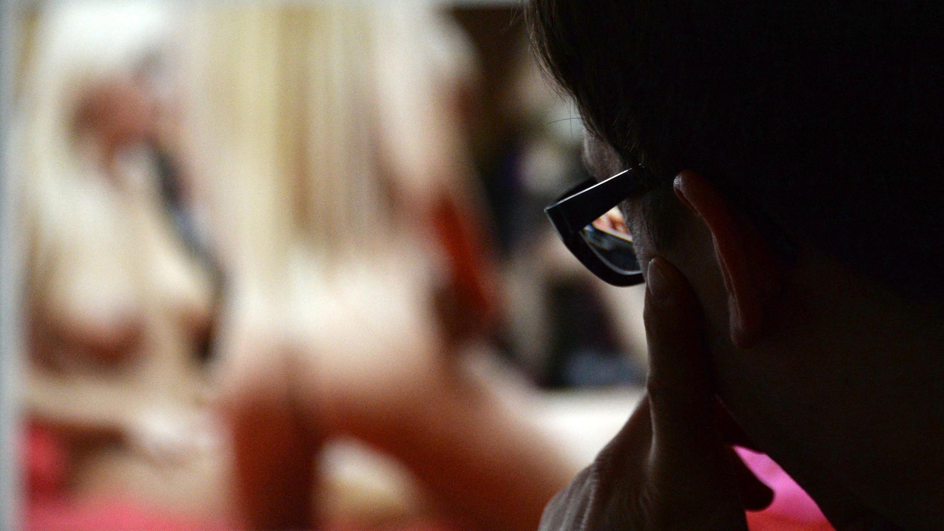 Mann schaut sich auf einem Bildschirm Erotikfotografien an