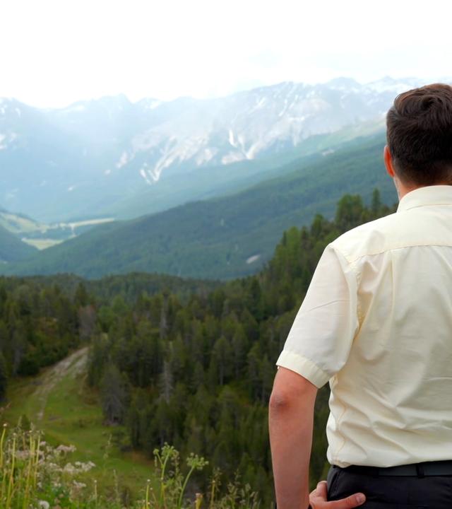 Mann von hinten blickt in Tal