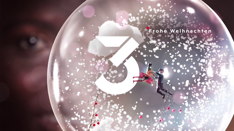 3sat Weihnachts-IDs 2019 : Nahaufnahme einer 3D-Schneekugel mit 3sat-Logo und der Aufschrift "Frohe Weihnachten"; darin ein schwebendes Figuren-Tannzpaar