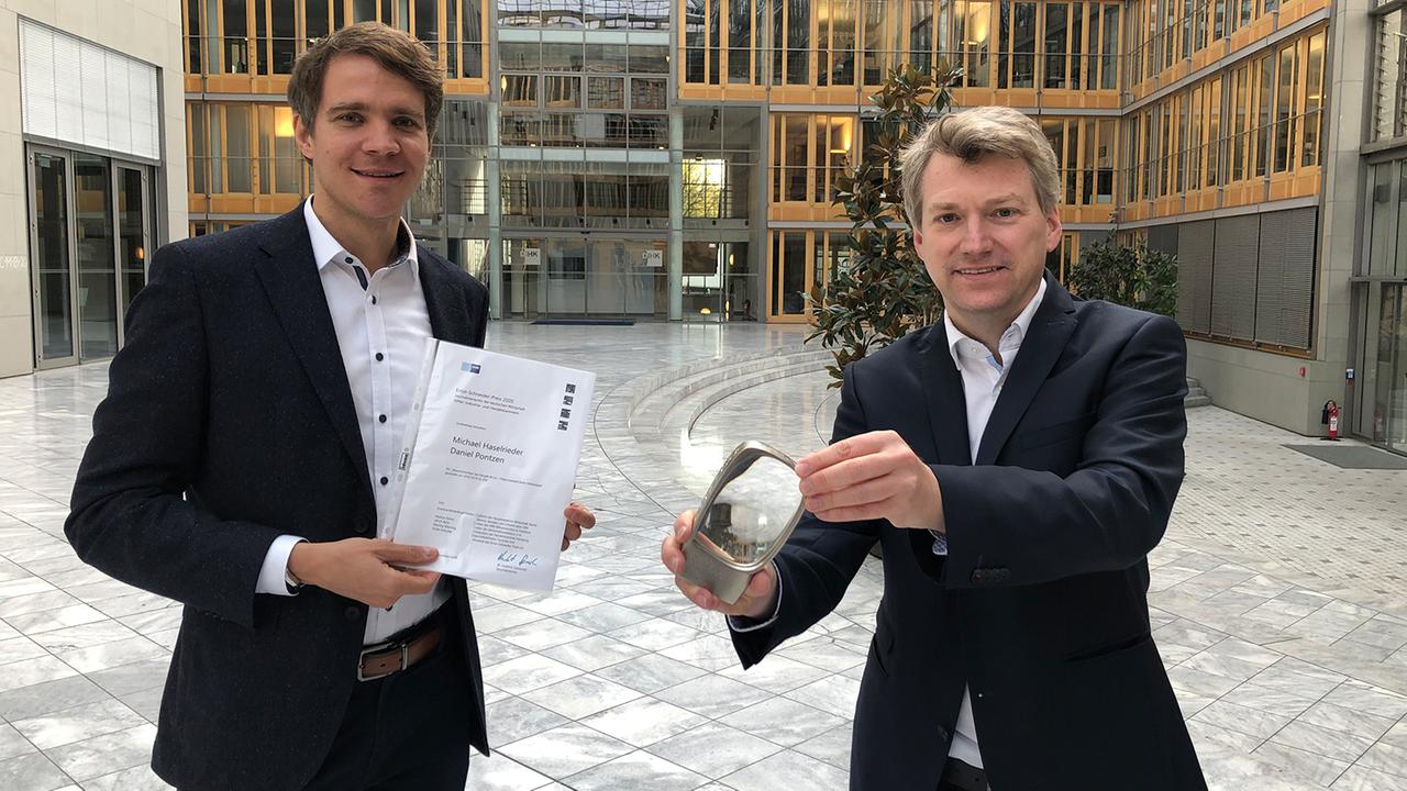 Ernst-Schneider-Wirtschaftsfilmpreis 2020: Die "Frontal 21"-Autoren Daniel Pontzen (r.) und Michael Haselrieder mit dem Prreis und der Preisurkunde.
