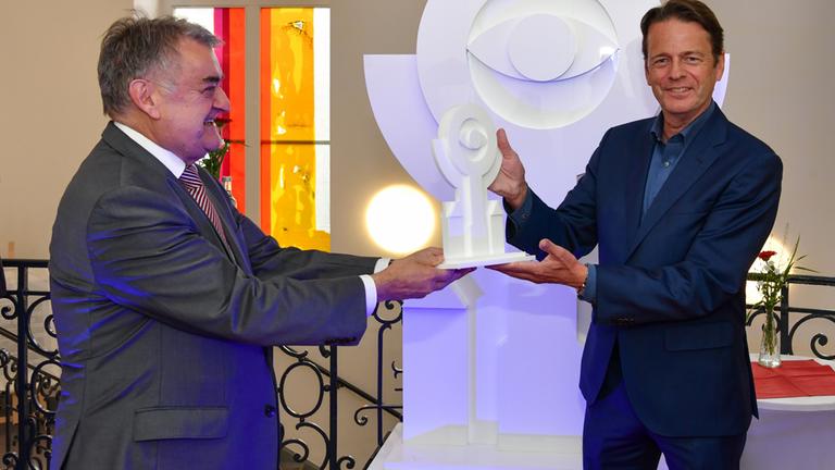 Verleihung "Polizei Award 2020" am 25.09.2020 in Essen: NRW-Innenminister Herbert Reul (l.) übergibt die Preistrophäe an "Aktenzeichen XY"-Moderator Rudi Cerne.