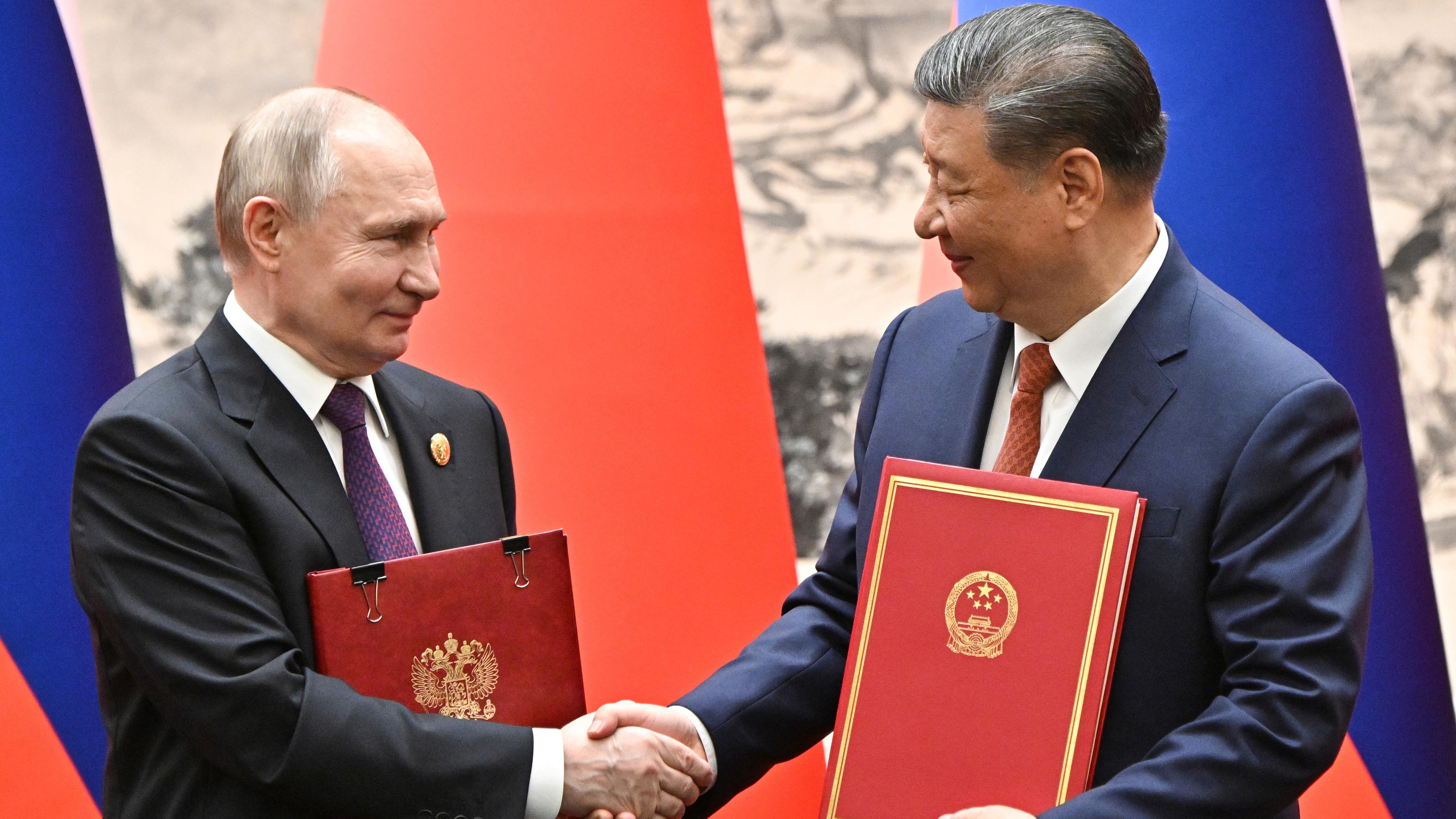 Chinese President Xi Jinping, right, and Russian President Vladimir Putin attend a signing ceremony in Beijing, China, on Thursday