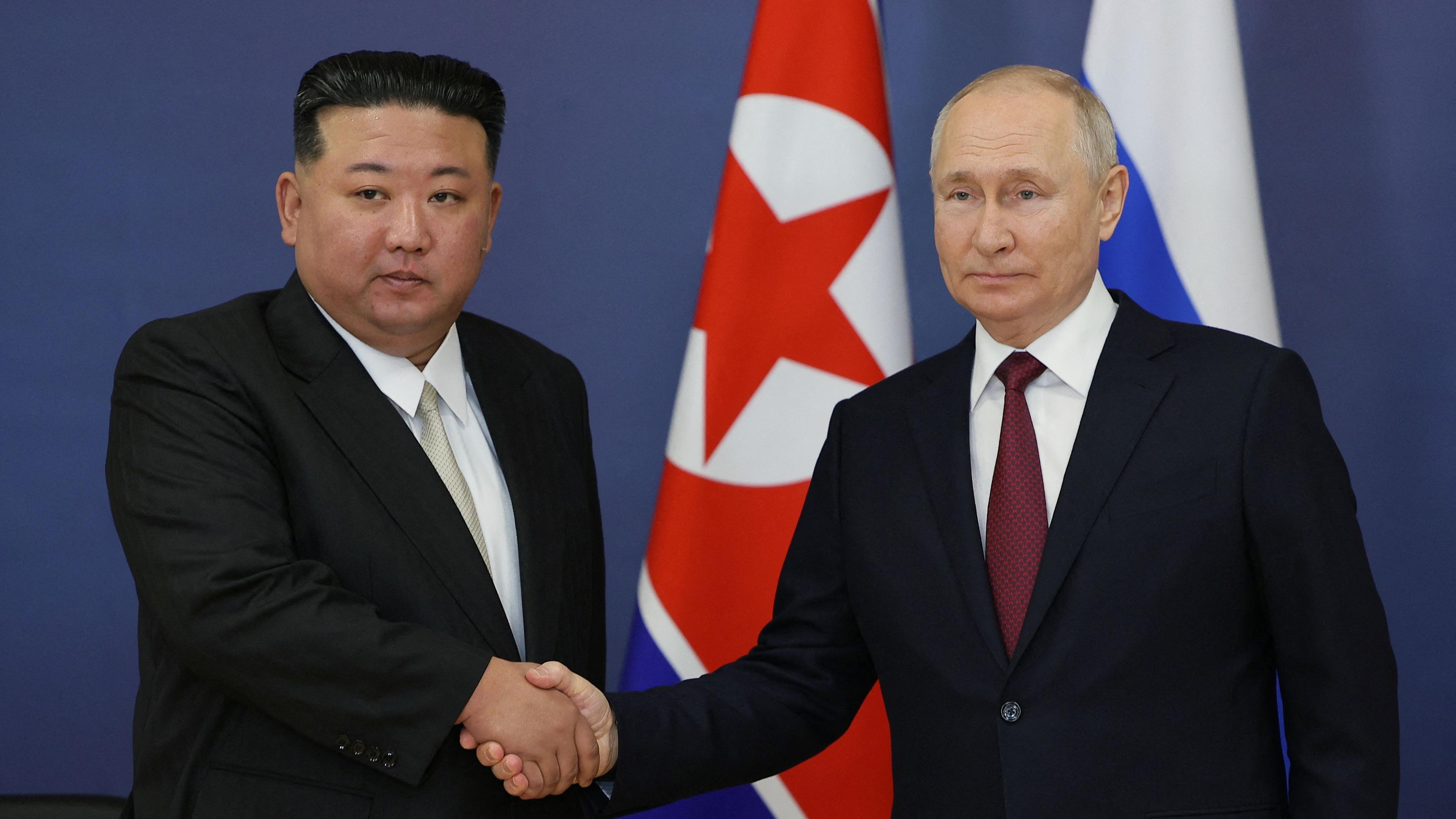 Russian President Vladimir Putin (R) and North Korea's leader Kim Jong Un (L) shaking hands during their meeting at the Vostochny Cosmodrome in Amur region on September 13, 2023. North Korea's top diplomat said her country is "ready to greet" Russian President Vladimir Putin