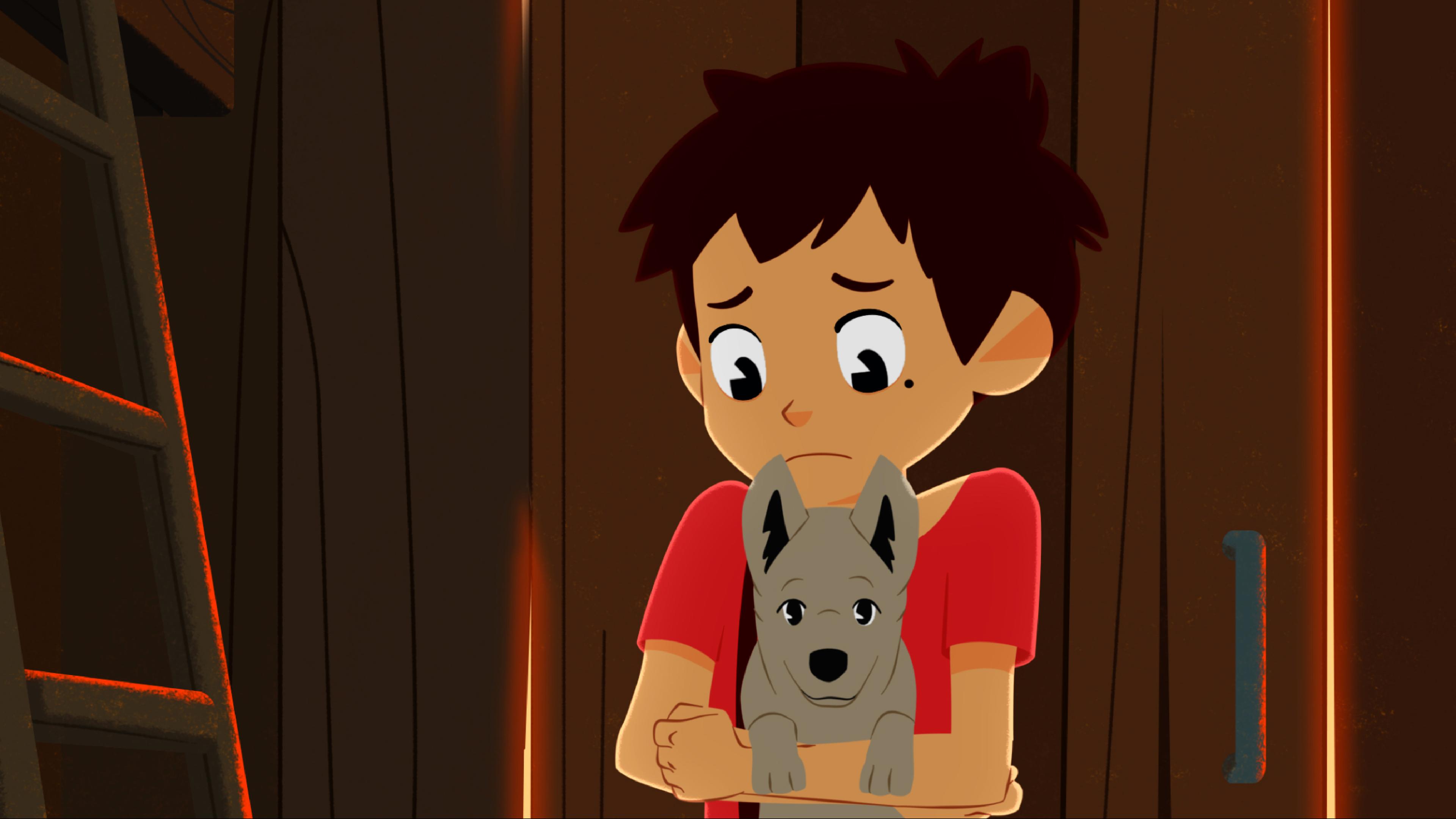 Sebastian hat einen Welpen auf dem Arm und guckt ihn besorgt an.