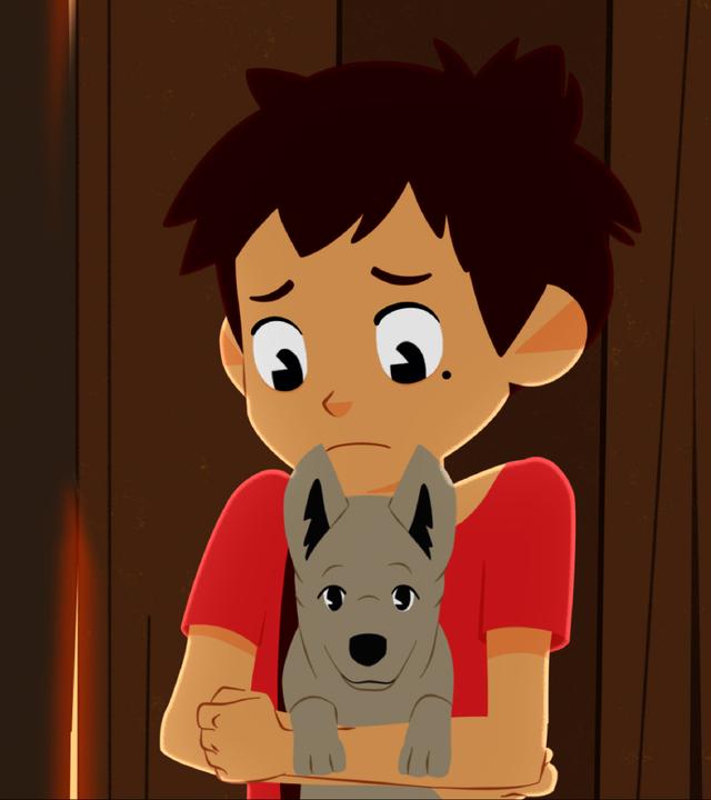 Sebastian hat einen Welpen auf dem Arm und guckt ihn besorgt an.