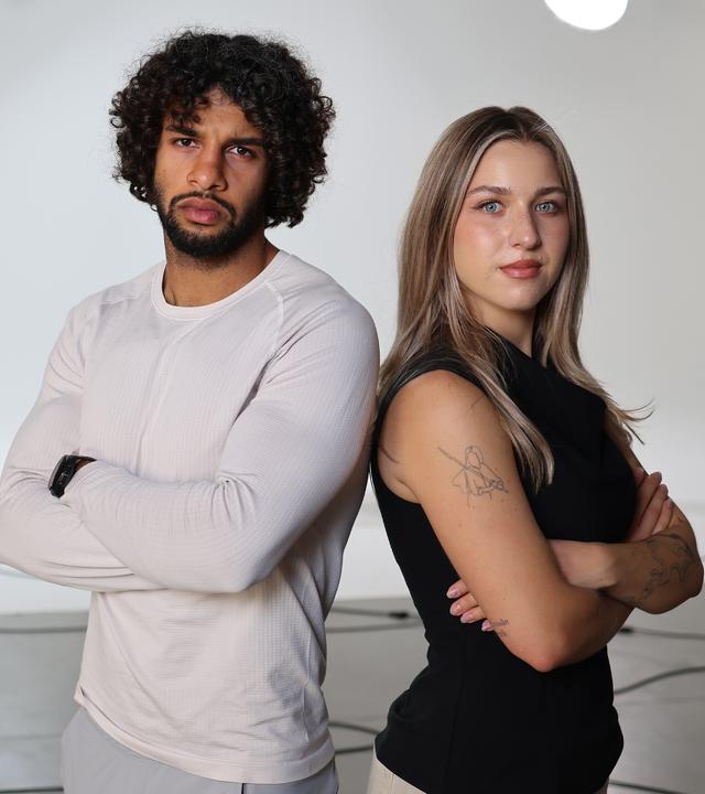 Fitness-Creator Rami Al-Azzawi (links) und Psychologiestudentin Julia Barabasch (rechts) stehen Rücken an Rücken und mit verschränkten Armen rechts im Bild.