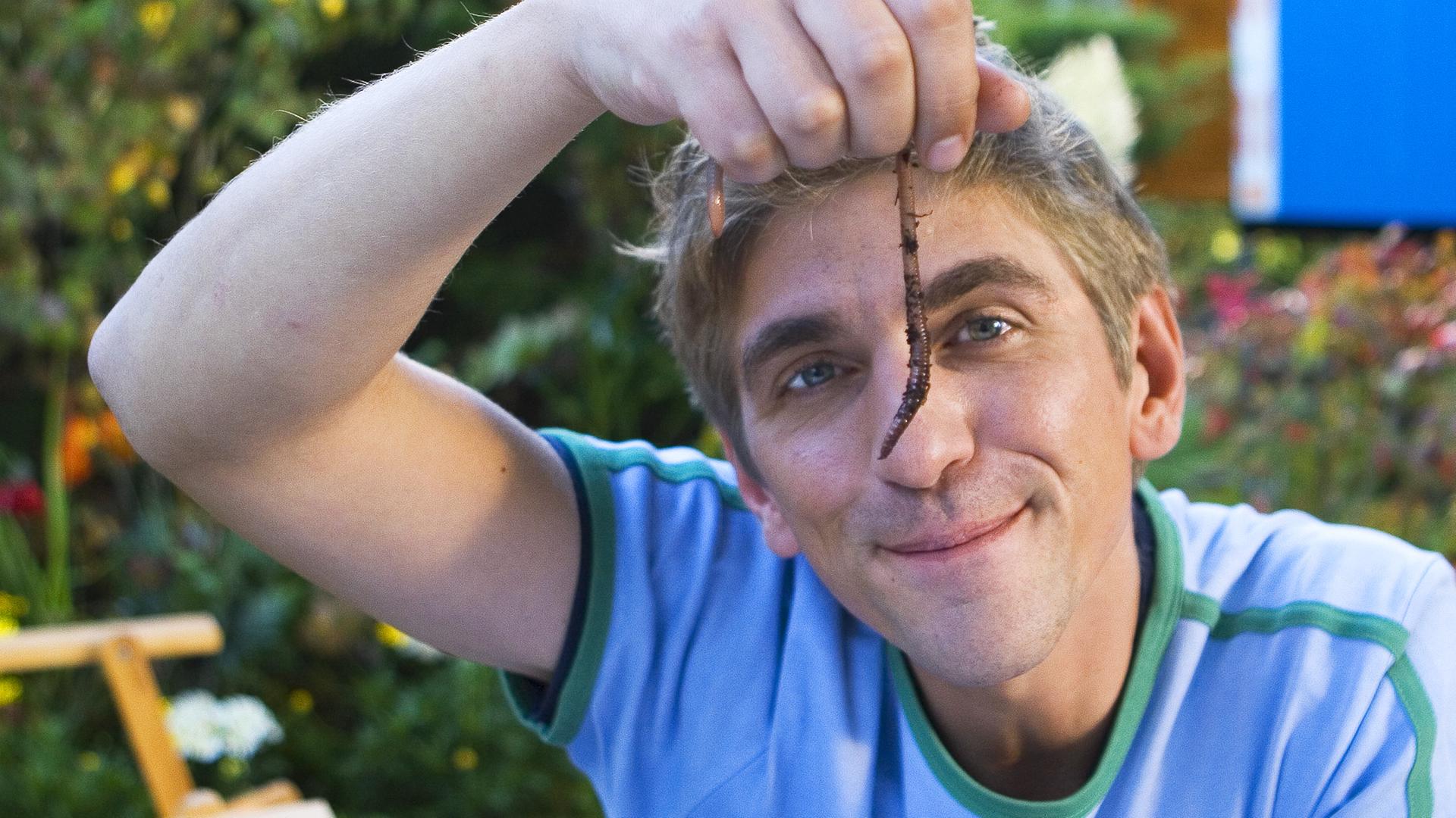 Fritz hält einen Regenwurm hoch