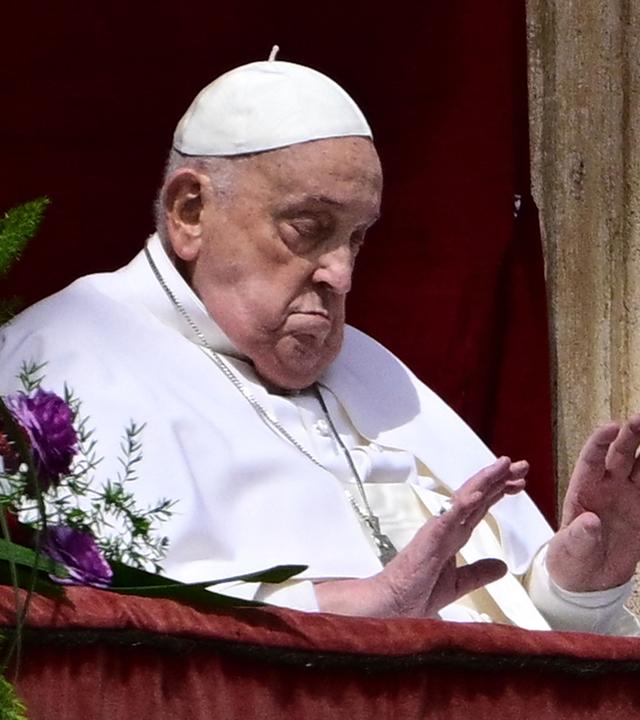 Pope Francis waves from the main balcony of St. Peter's basilica during the Urbi et Orbi message and blessing to the city and the world as part of Easter celebrations, at St Peter's square in the Vatican.
