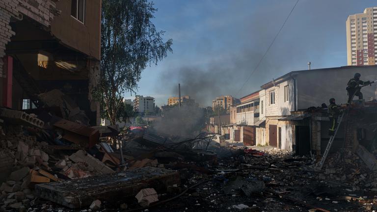 Rettungskräfte löschen am Dienstag, dem 2. Juni 2026, in Kiew (Ukraine) einen Brand in einer Autowerkstatt, die durch einen russischen Angriff beschädigt wurde.