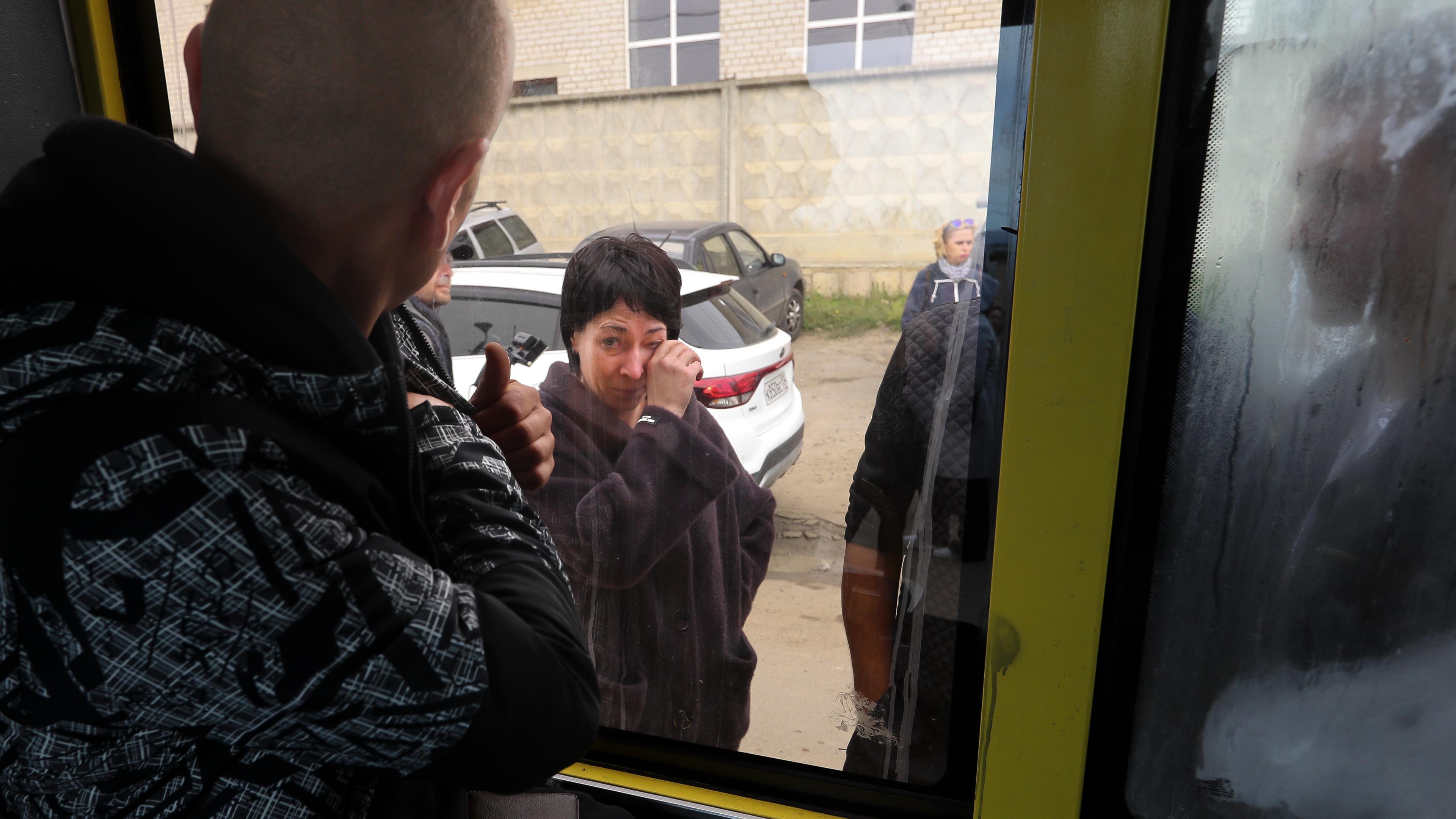    Russia, Volgograd: A Russian soldier looks out of the bus window at his mother, whom he had to leave behind at the military recruitment centre. 