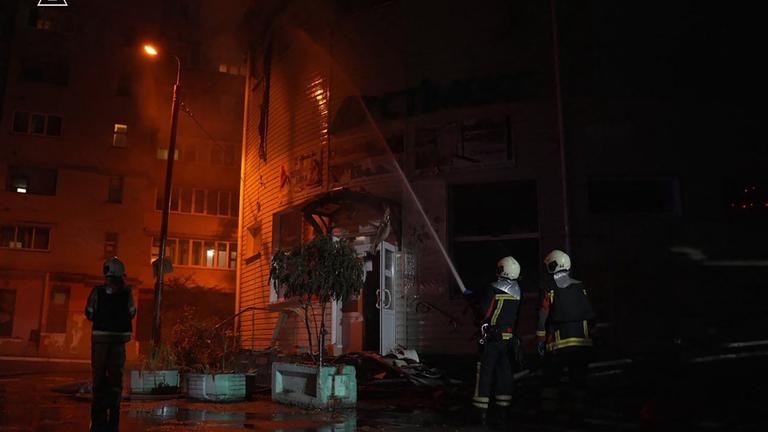 Rettungskräfte, die am Ort eines russischen Angriffs in Kiew im Zuge der russischen Invasion in der Ukraine im Einsatz sind. 