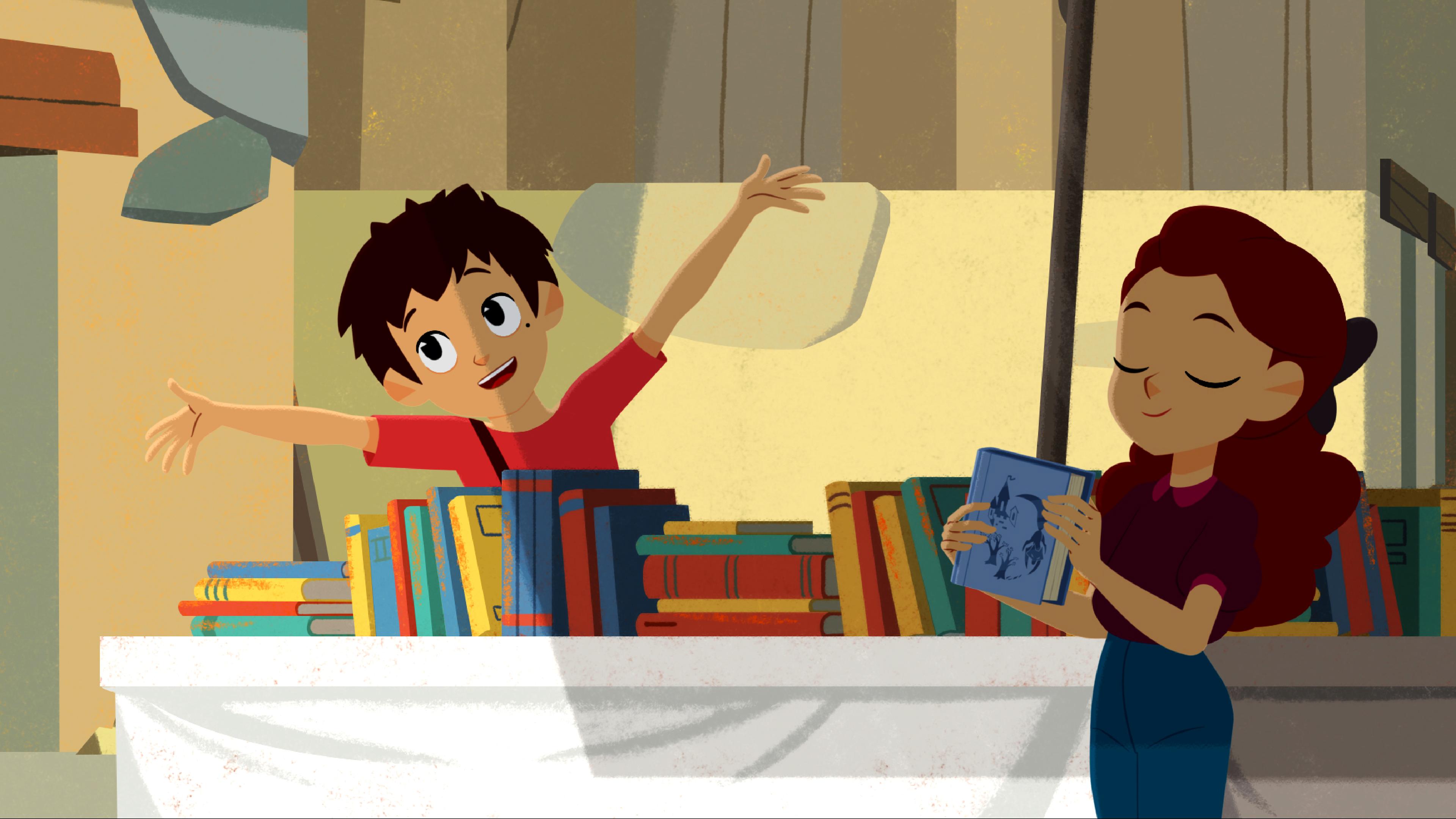 Sebastian steht hinter einem Tisch voller Bücher und wirft fröhlich die Arme nach oben. Adele steht davor und hält ein Buch in der Hand.