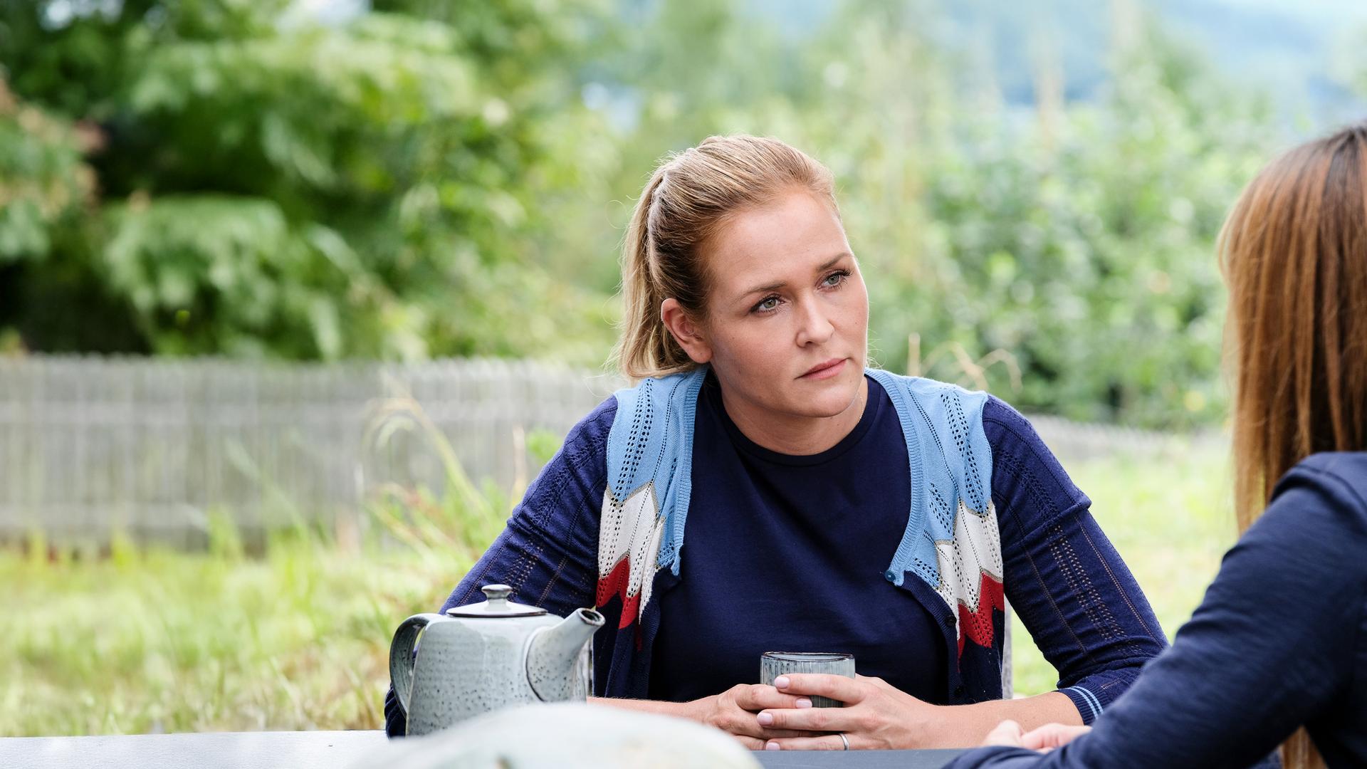 "Lena Lorenz - Schatten und Licht": Lena Lorenz (Judith Hoersch) sitzt Isabel Petri (Ina Paule Klink) gegenüber und schaut diese ernst an. Eine Teekanne steht auf dem Tisch.