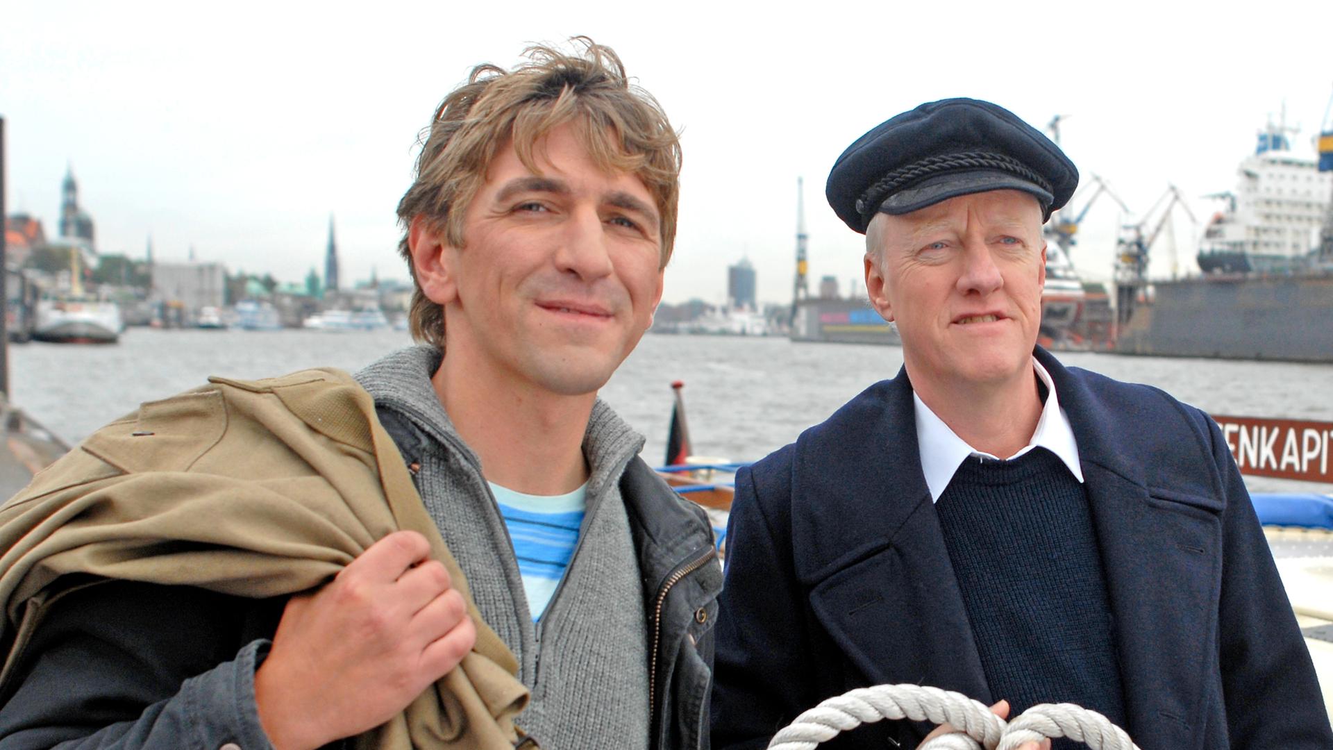 Fritz Fuchs und der Decksmann stehen am Hafen.