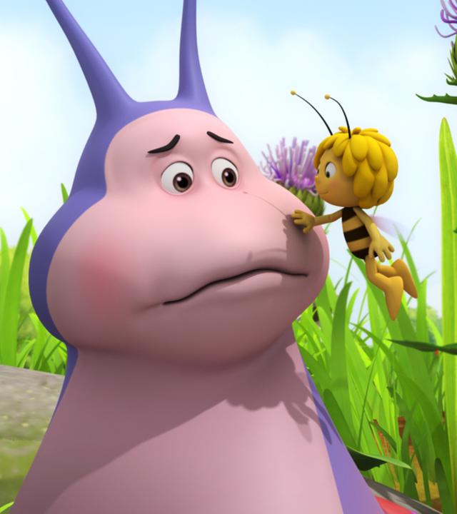 Maja tröstet Schnecke Heinz und fasst ihm an die Wange.