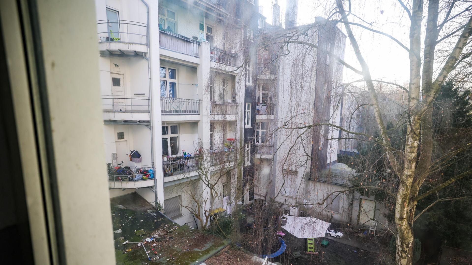 Blick aus dem Fenster eines Hausflurs einer Schrottimmobilie in einen Innenhof.