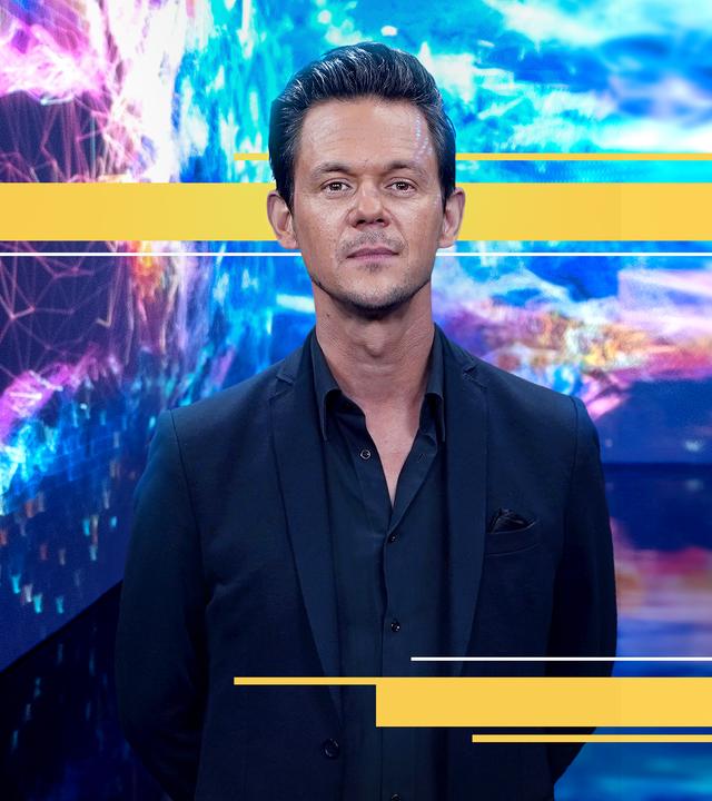 Jo Schück vor bunter Videowand in der KI-Ausstellung "Digital by Nature" in der Kunsthalle München.