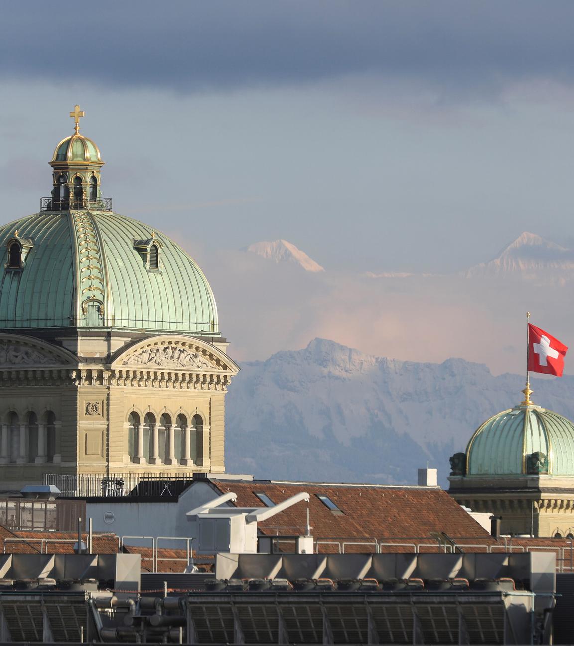 Zu sehen ist das schweizer Bundeshaus, mit den Alpen im Hintergrund.