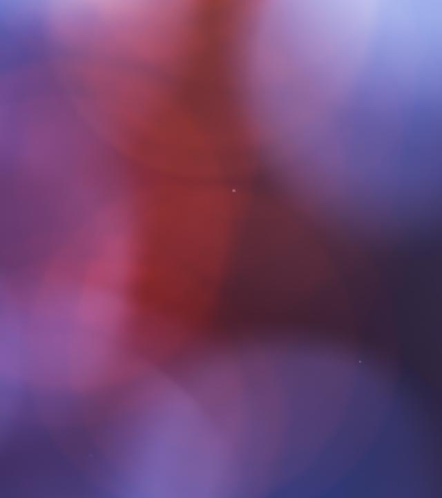 Abstraktes Bild: Weiche, verschwommene Lichtflecken in verschiedenen Farben erzeugen eine atmosphärische, leuchtende Fläche. Das Bild symbolisiert die Wirkung von Scheinwerfern und Lichtstimmung in Shows.
