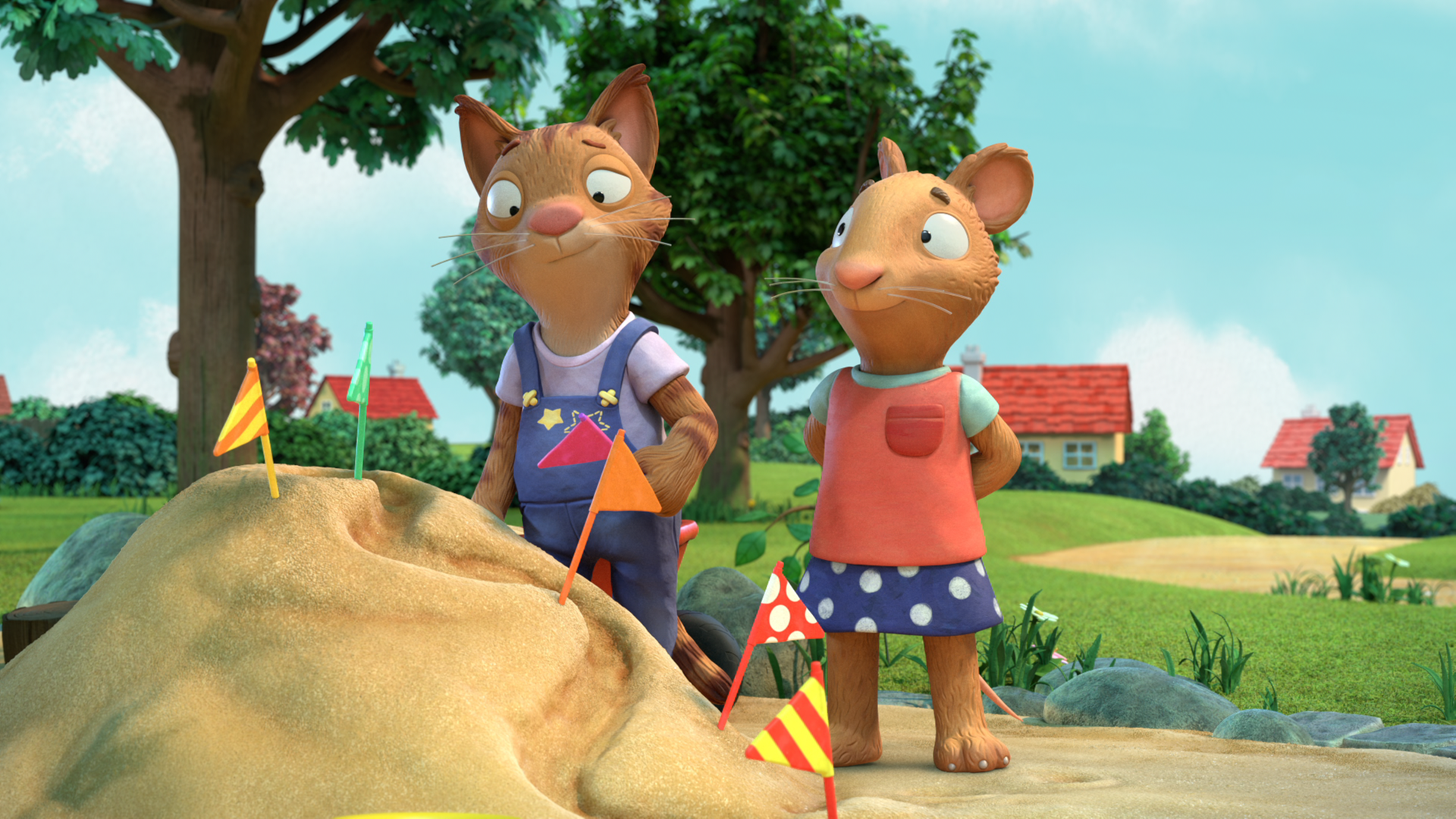 Frankie, die Katze, und Posy, die Maus, befinden sich in einem Sandkasten. 