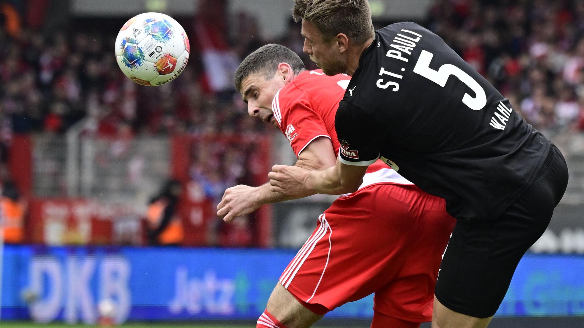 Andrej Ilic (Union Berlin) und Hauke Wahl (St Pauli) kämpfen. 