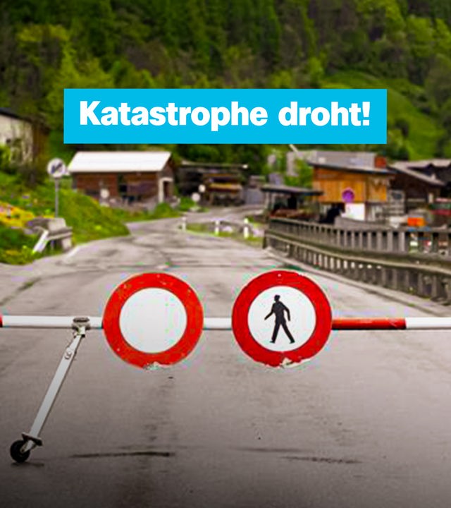Abgesperrtes Bergdorf mit Aufschrift "Katastrophe droht"