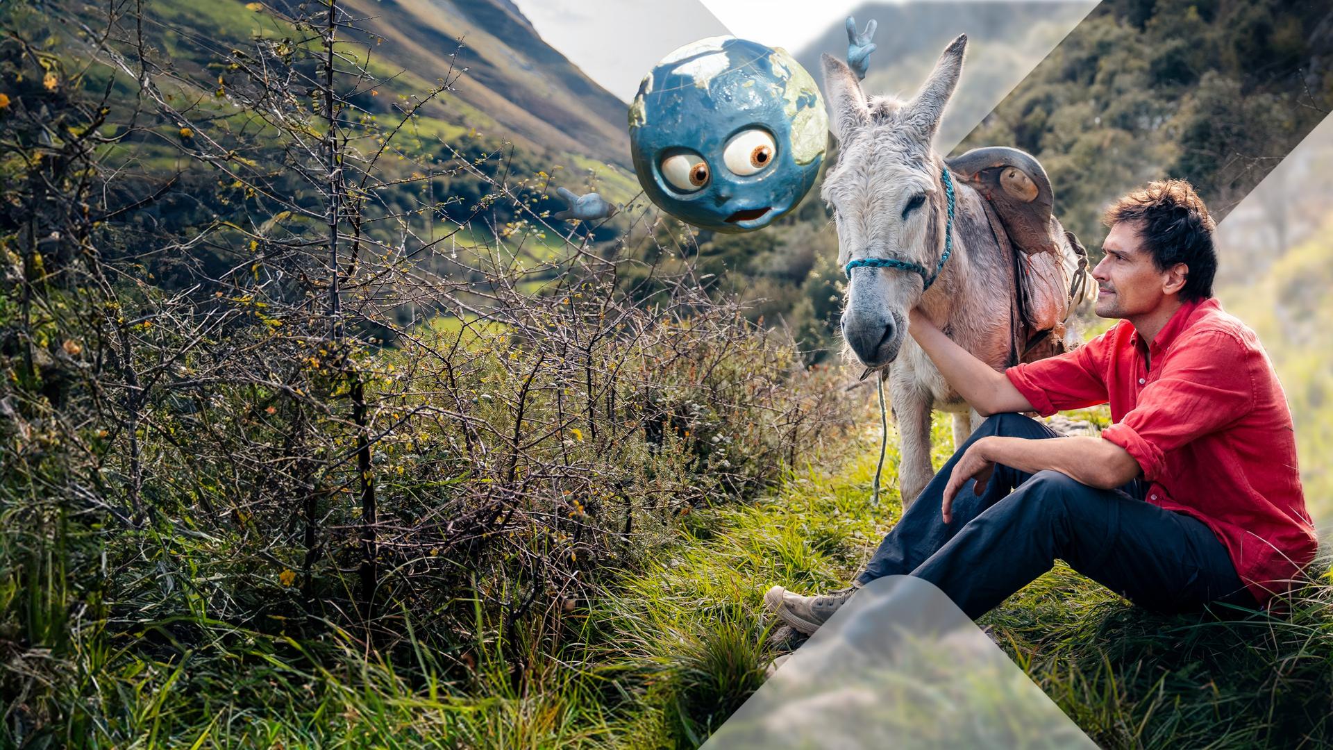 Uli Kunz mit Esel und animierter Weltkugel