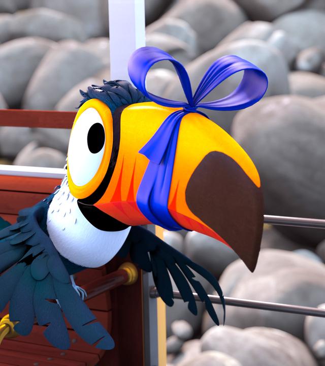 Tukan Toni hat seinen Schnabel mit einer blauen Schleife zugebunden.