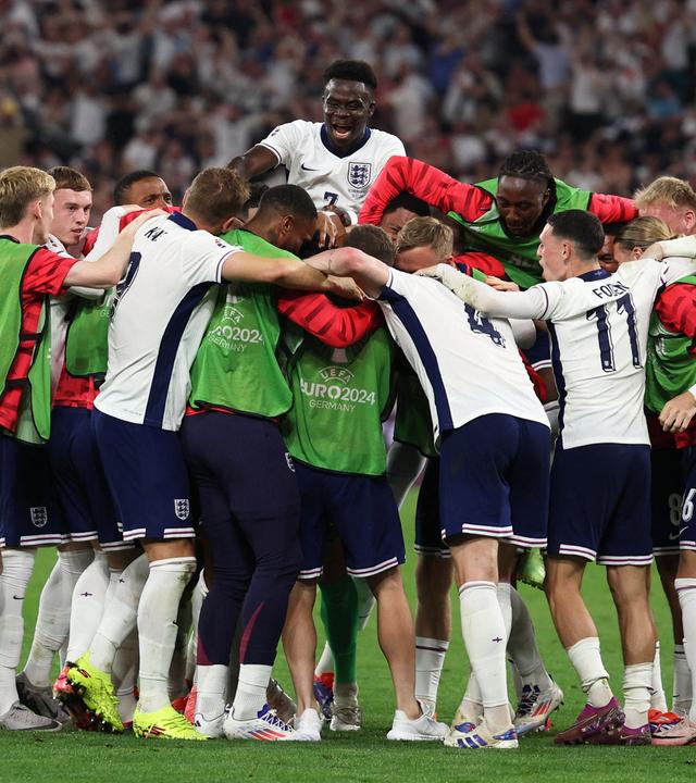 England's players celebrate after winning the UEFA Euro 2024 semi-final football match