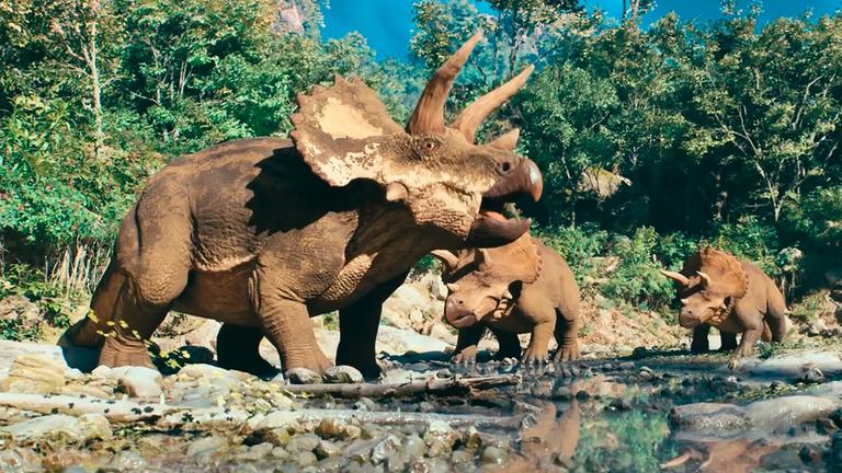 Computeranimiertes Bil von drei Triceratops an einer Wasserstelle.