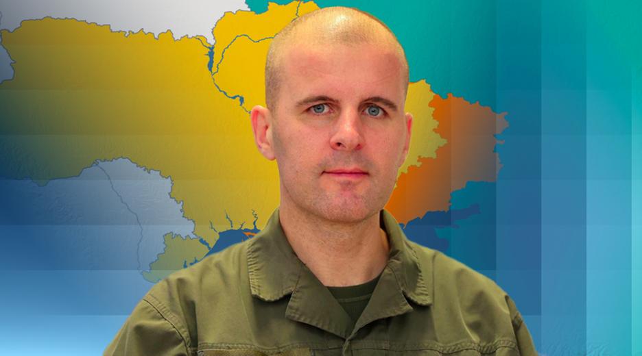 Oberst Reisner ist vor einer Karte der Ukraine abgebildet.