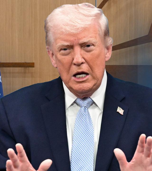 Trump vor einer Flagge der USA und dem Nato-Logo beim Sprechen.