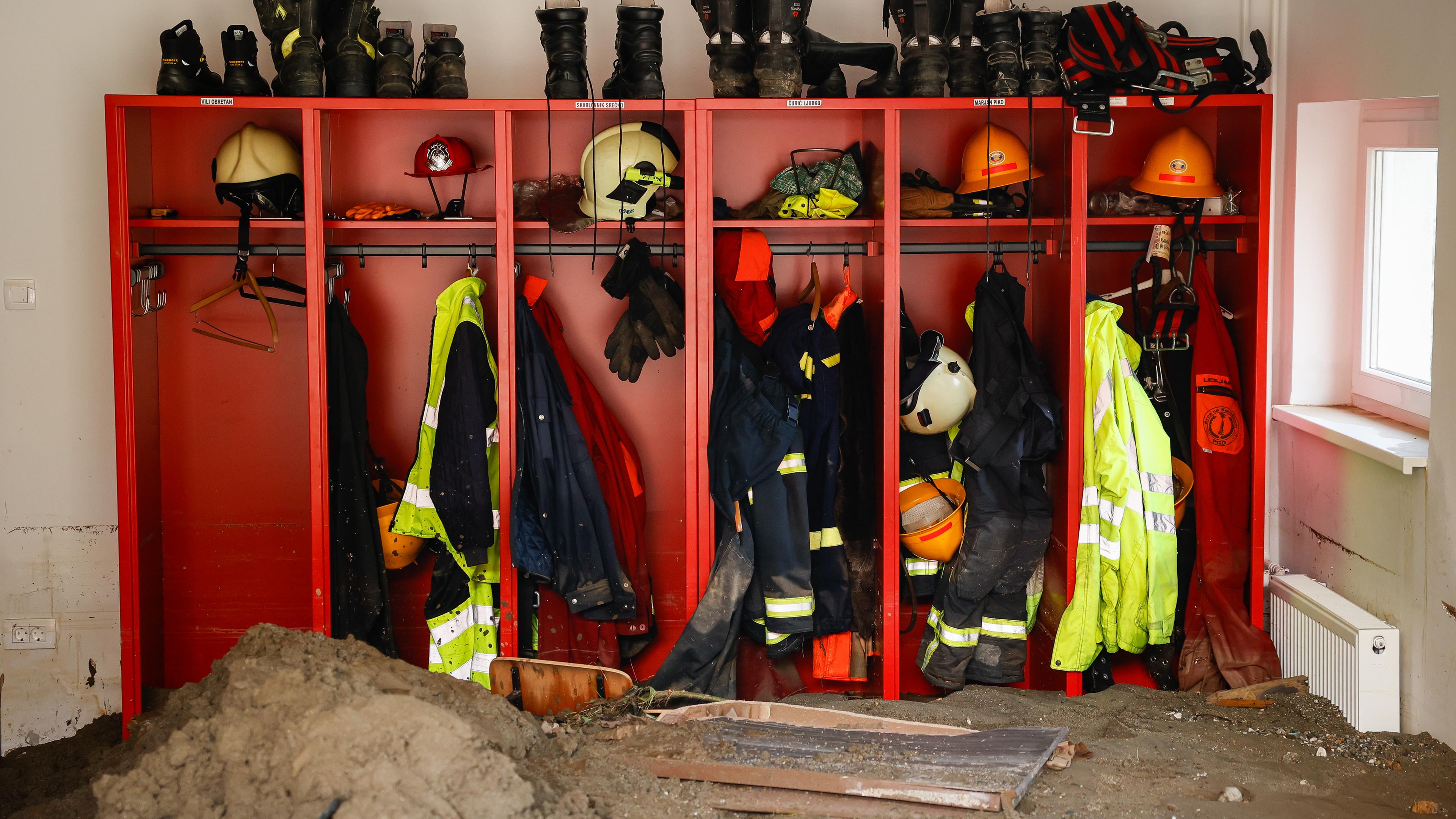 Die Uniformen der Rettungskräfte hängen in einem offenen Schrank. 