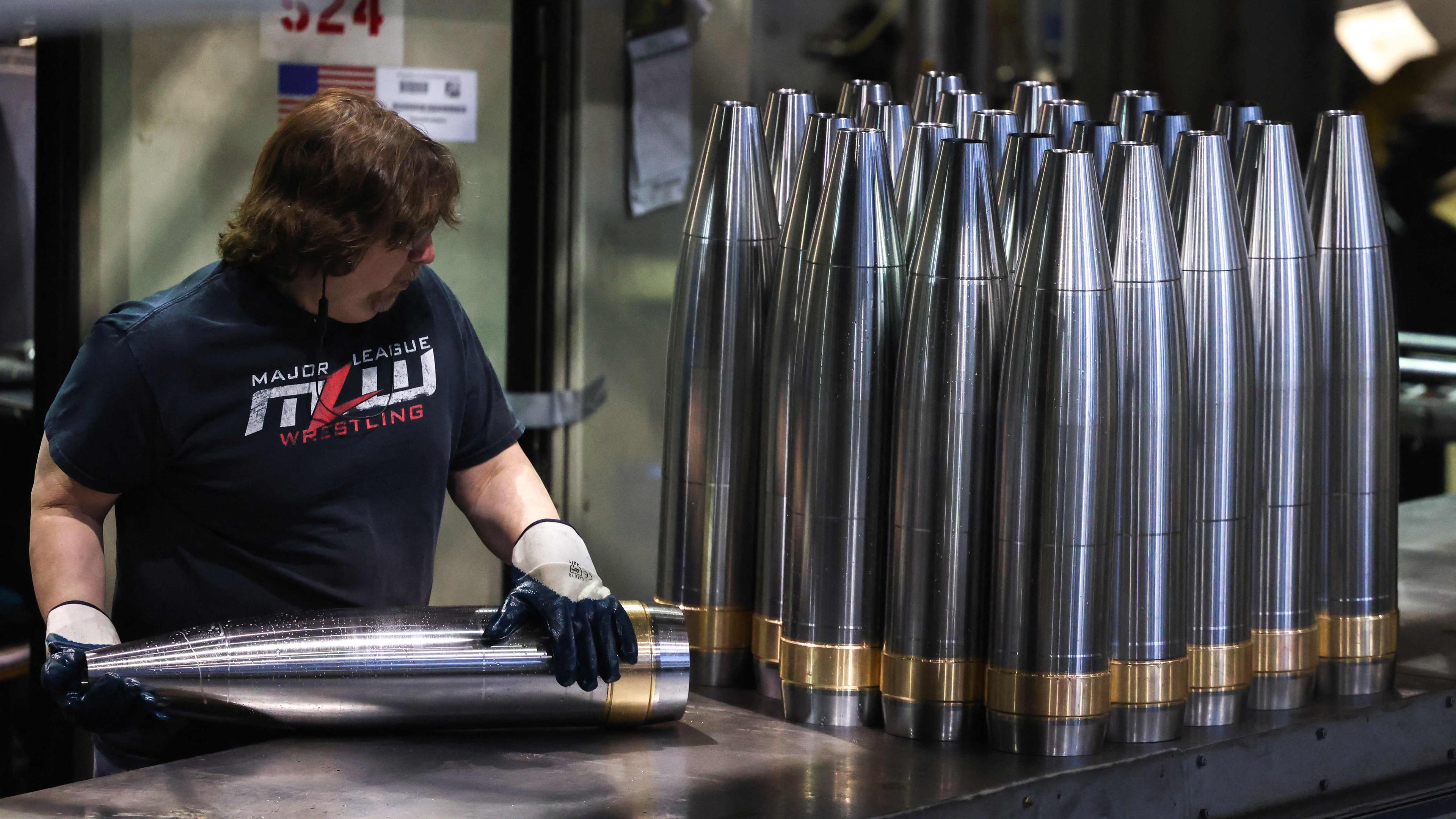 An employee handles 155 mm caliber shells after the manufacturing process at the Scranton Army Ammunition Plant (SCAAP) in Scranton, Pennsylvania on April 16, 2024. 