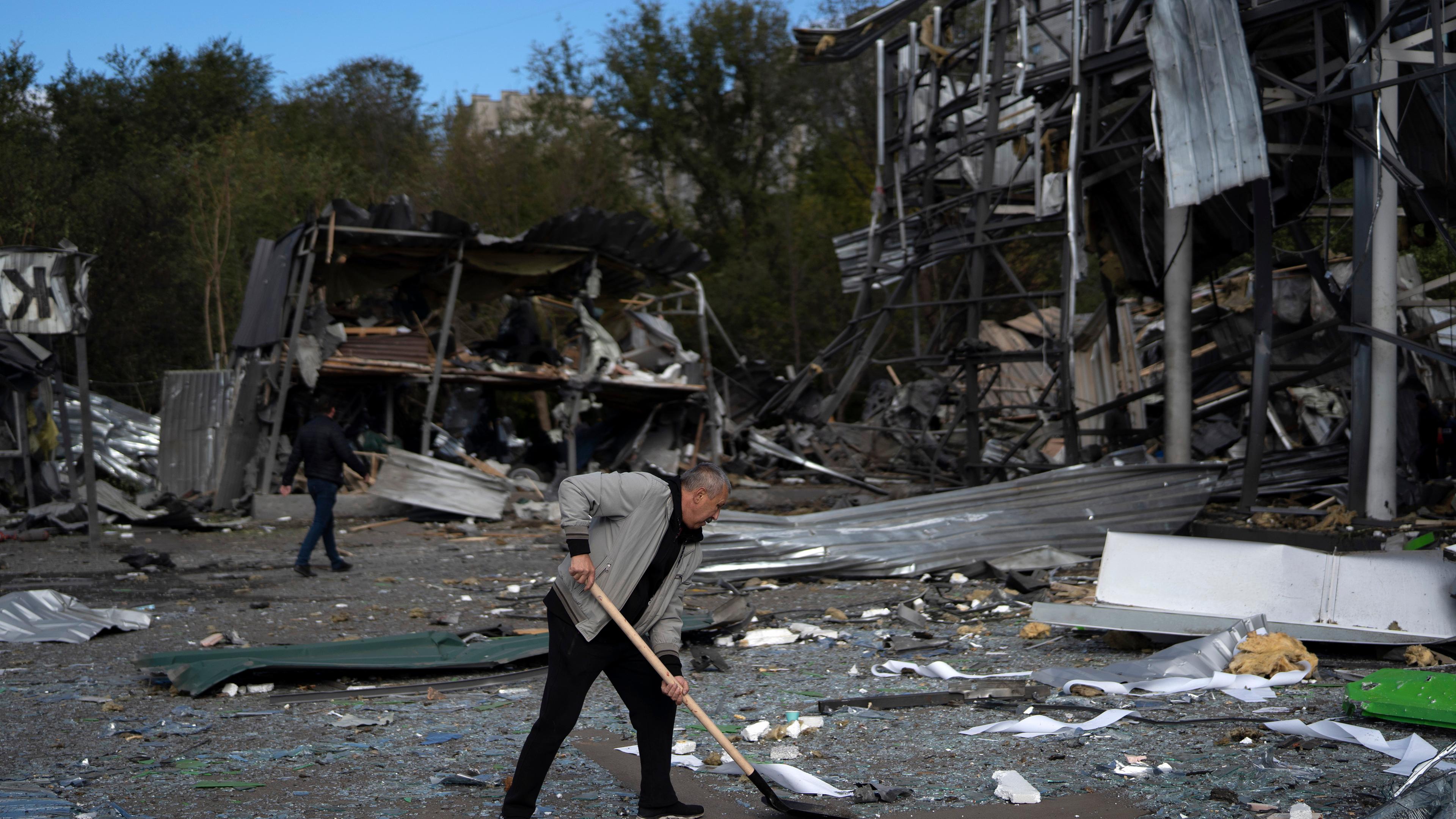 The man clears the debris of a building after a Russian attack.  Zaporizhia, Ukraine.