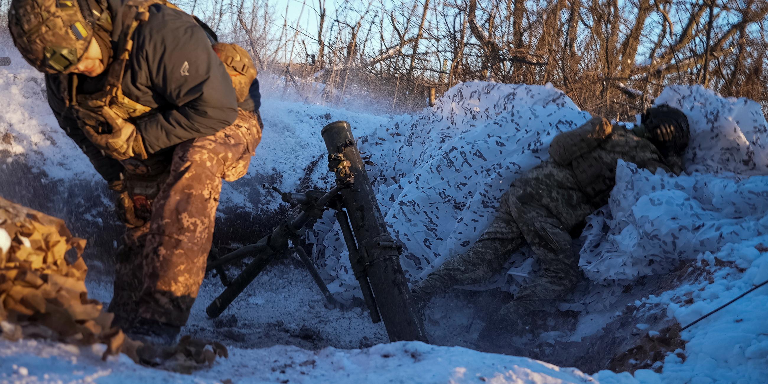 Ukrainian servicemen fire a 120-mm mortar towards Russian troops at a position near Bakhmut
