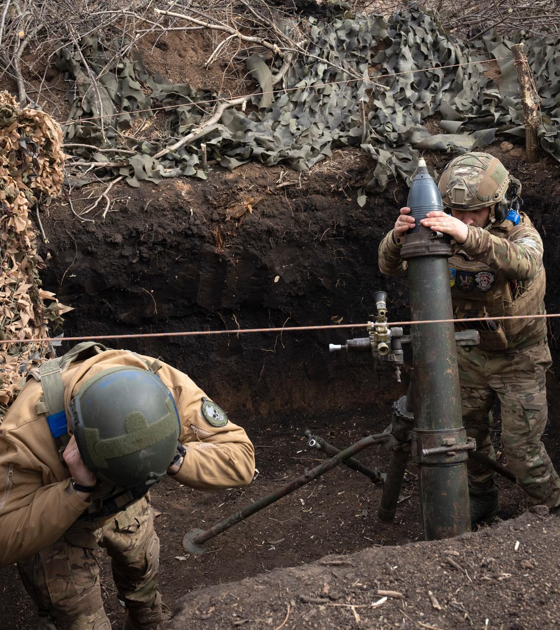 Ukrainian servicemen of the 28th Separate Mechanised Brigade fires a 122mm mortar towards Russian positions at the front line, near Bakhmut, Donetsk region, Ukraine, Sunday, March 3, 2024.