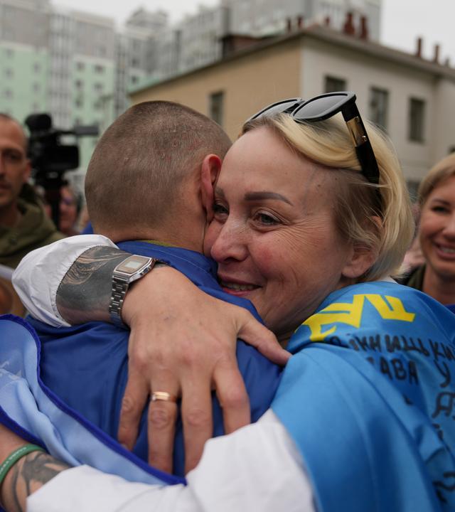 Ukrainian servicemen meet with their relatives after they were released from Russian captivity, at an undisclosed location on 06 May 2025.