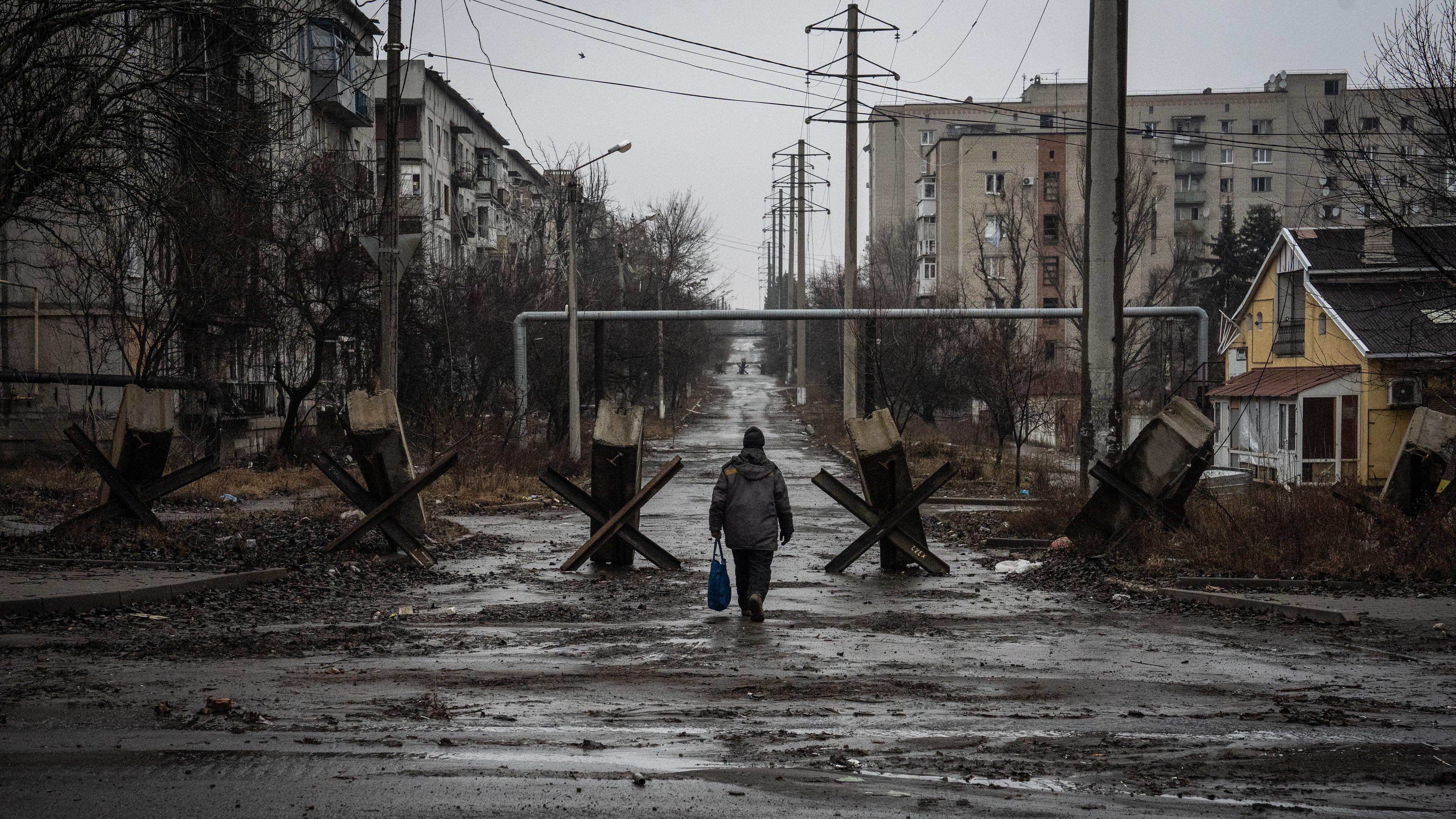 Ein Mann läuft über eine verlassene, verfallene Straße.