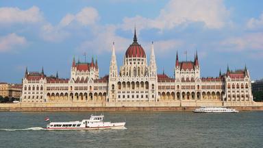 Ein Schiff fährt auf der Donau in Budapest, vor dem ungarischen Parlamentsgebäude.
