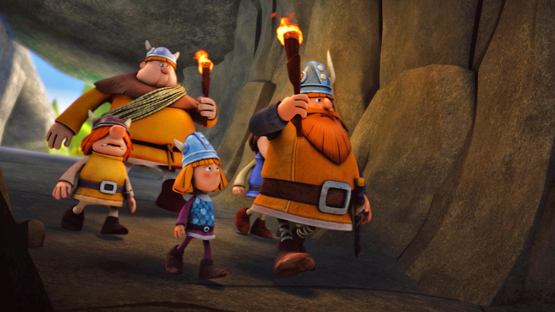 Wickie, Snorre, Faxe und Halvar laufen mit Fackeln durch eine Höhle.