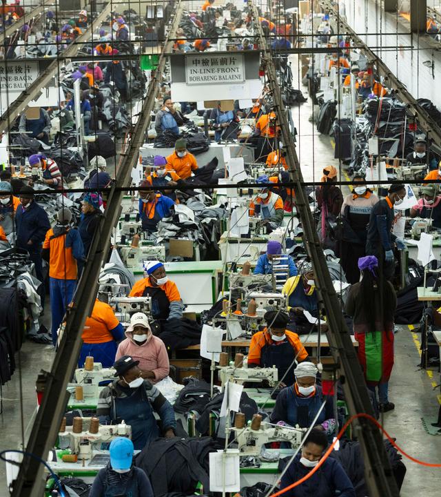 Workers at the Nien Hsing International Garment's Factory produce Levi jeans for the US market in Maseru, Lesotho