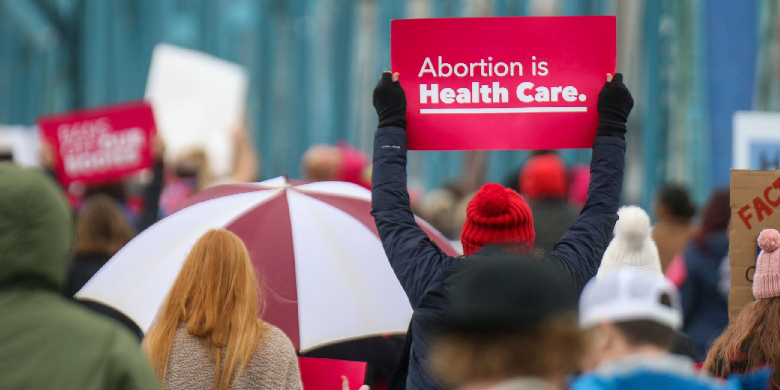 Demonstranten auf den Straßen von Chattanooga, Tennessee in den USA. Eine Person hält ein Schild mit dem Text "Abortion is Health Care.".