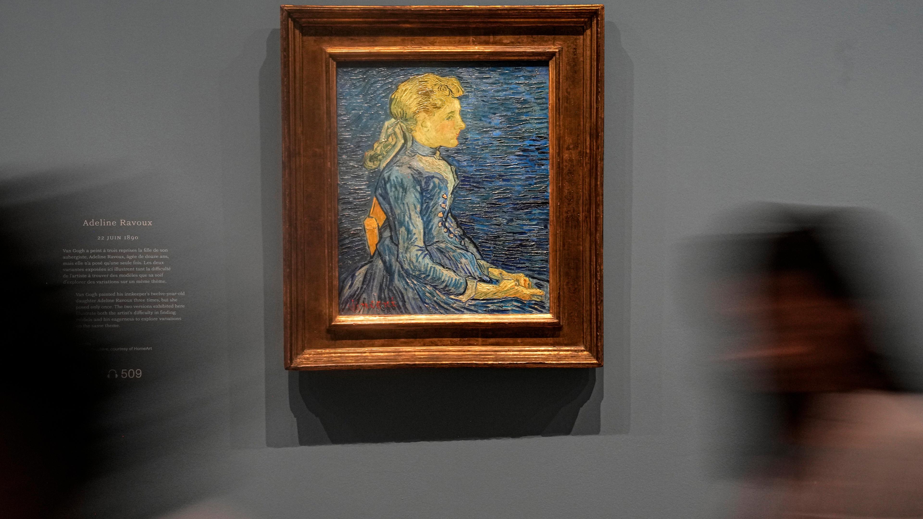People walk past Vincent Van Gogh's oil on canvas painting "Adeline Ravoux", painted on June 22, 1890, during the press day at the "Van Gogh in Auvers-sur-Oise: The Final Months" exhibition at the Musee d'Orsay in Paris, Friday, Sept. 29, 2023.