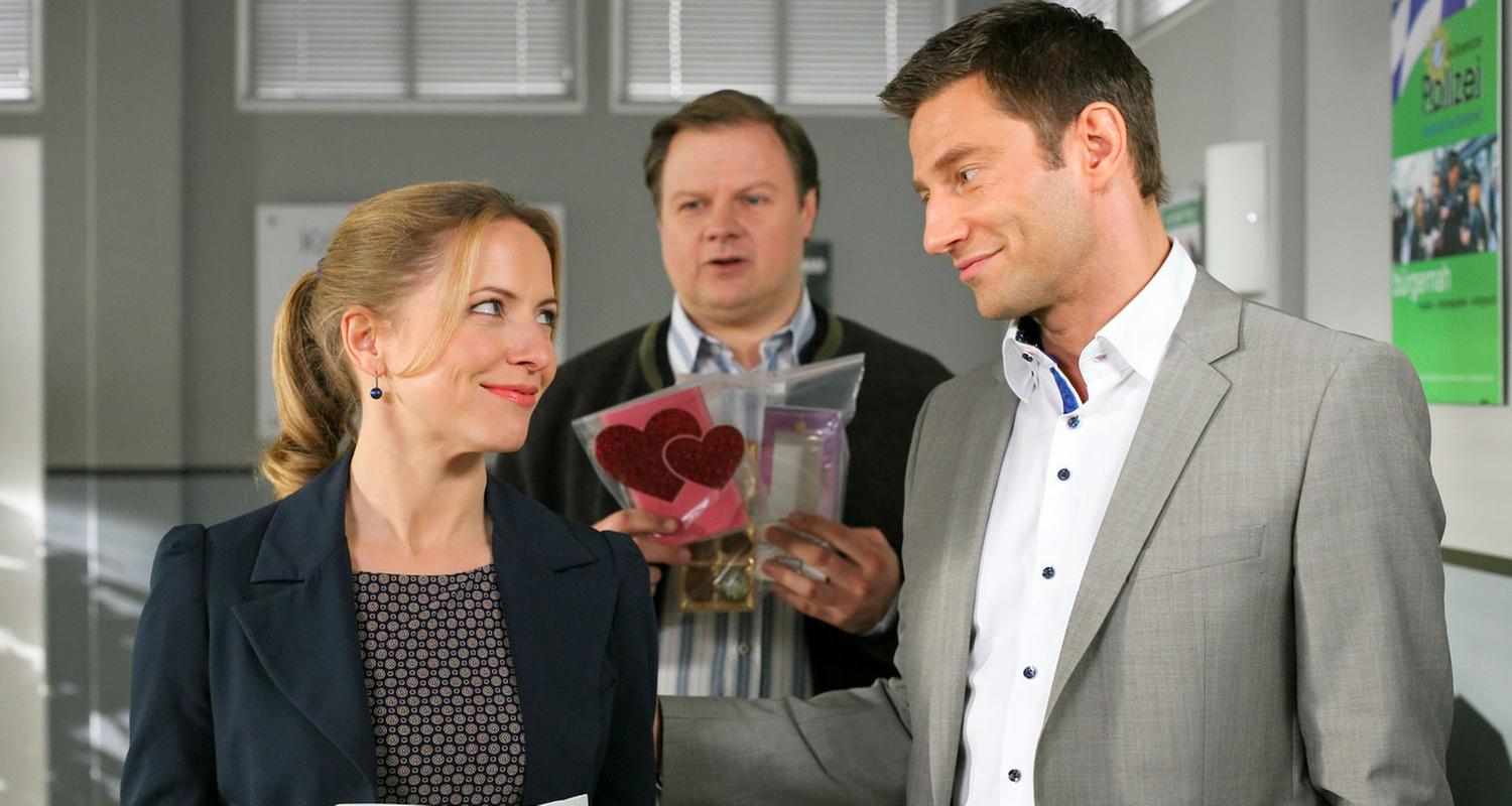 "Die Rosenheim-Cops - Vergiftetes Glück": Im Flur des Kommissariats stehen Controllerin Ortmann (Diana Staehly) und die Kommissare Hansen (Igor Jeftic) und Hartl (Michael A. Grimm).