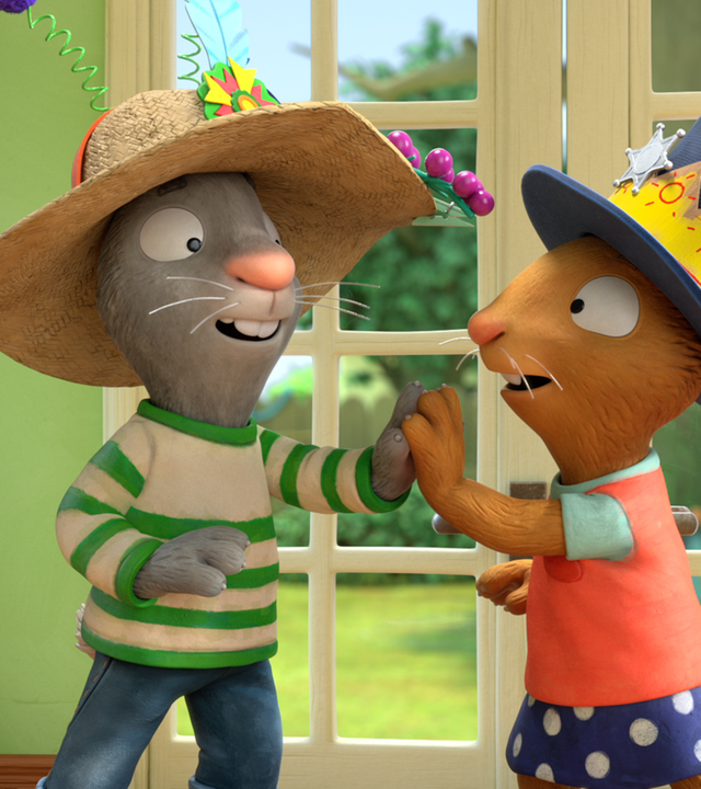 Pip begrüsst Posy, die beide einen bunt geschmueckten Hut tragen.