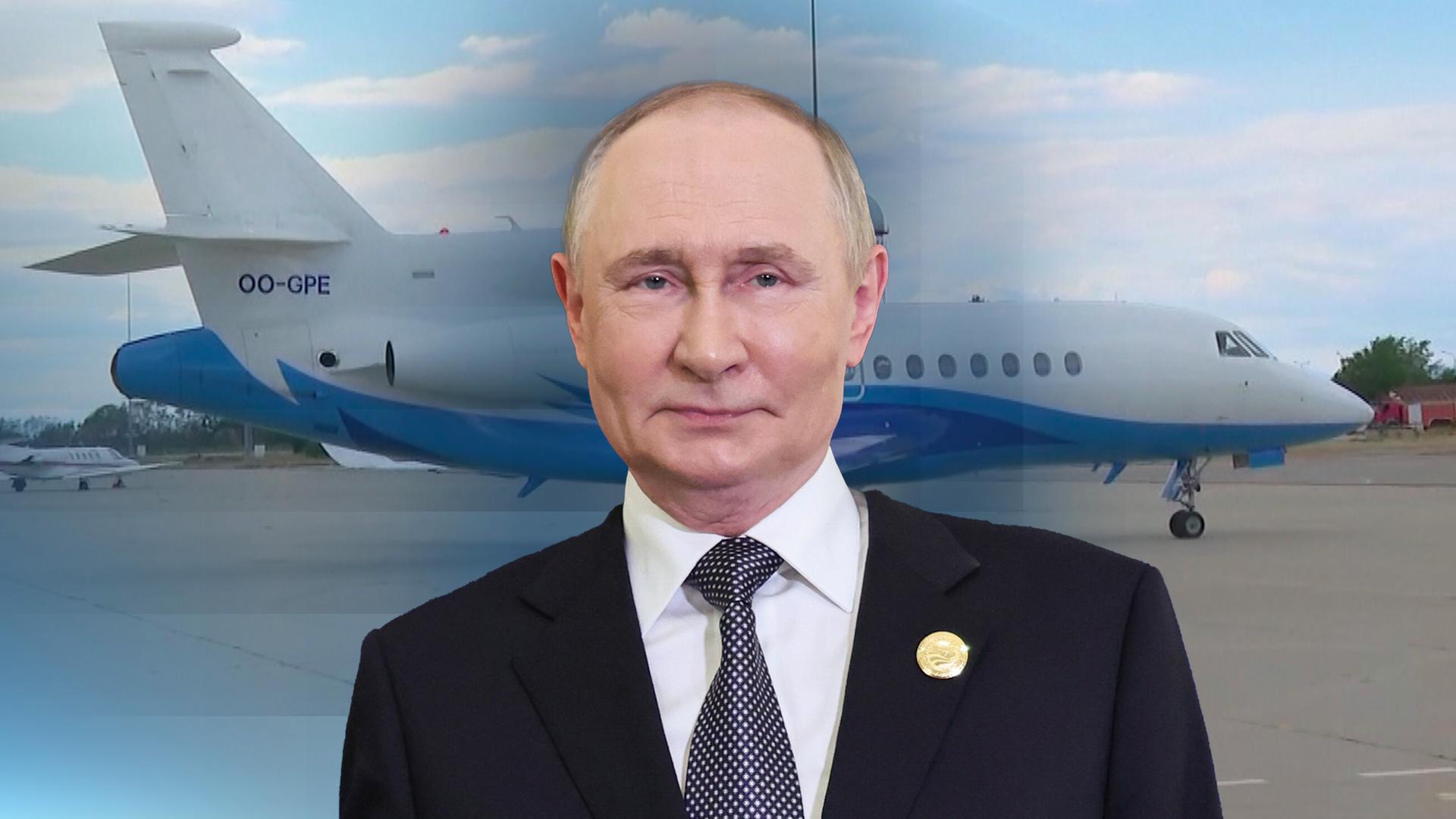 Wladimir Putins Kopf vor einem Flugzeug. 