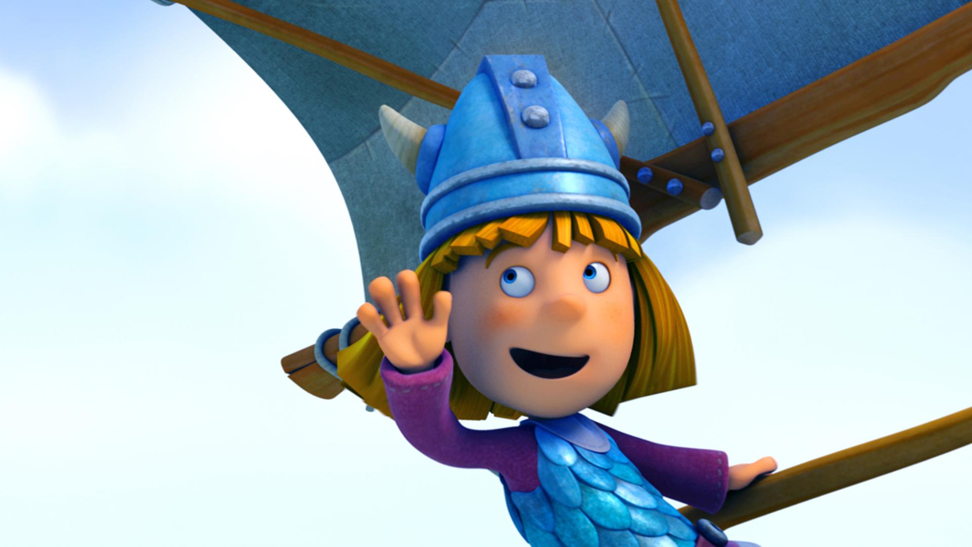 Wickie hat Spaß beim Segeln und winkt jemandem zu.